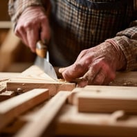 a close up image of an amish craftsman chiseling solid wood